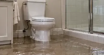 Bathroom floor covered with overflow water