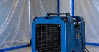 HEPA air scrubber filtering airborne particles
